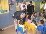 7.	Mr. Edmond Beck speaks with the children in a preschool class
