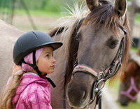 רכיבה טיפולית - ילדה מתקשרת עם סוס