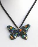 This butterfly pendant is made of fused glass with dark based dichroic with a silver bail. The necklace comes with an adjustable suede cord (as shown in the picture) or with a rhodium plated chain.
